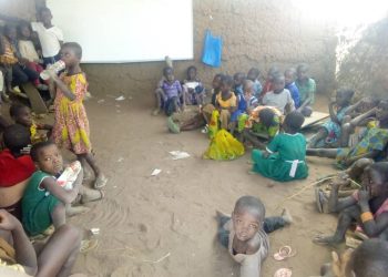 Pupils of Tampoi R/C Primary Lie On Bare Floor To Learn.